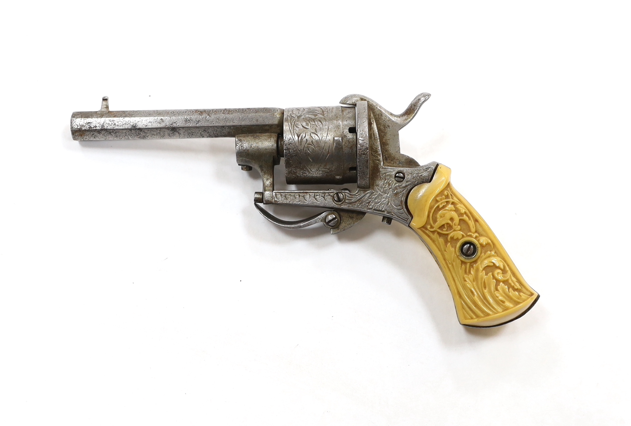 A six shot, 7mm Belgian self cocking pinfire revolver, octagonal barrel, roll engraved frame and cylinder fitted with two piece moulded casein grips
